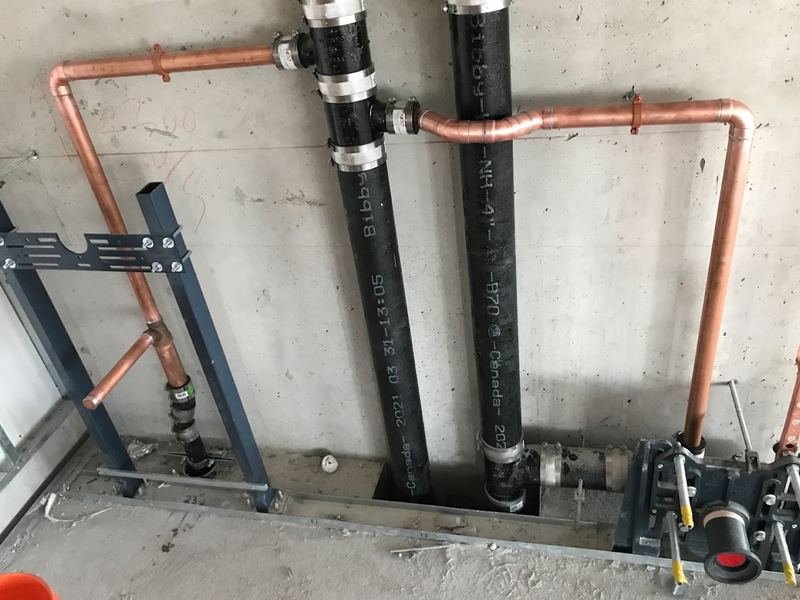 Cast iron stacks and copper risers on a commercial rough-in