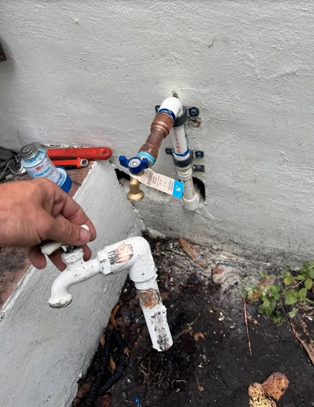 New frost-free hose bib installed beside the old cast outdoor tap