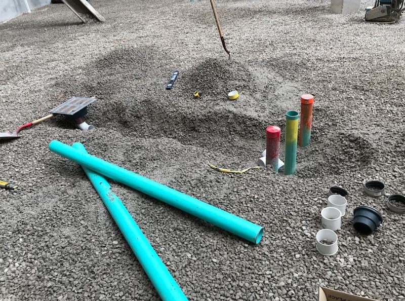 Underslab drain rough-in stubbed and capped in gravel, ready for inspection
